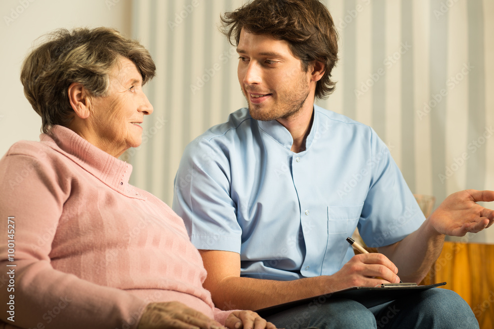 Fototapeta premium Senior female talking with doctor