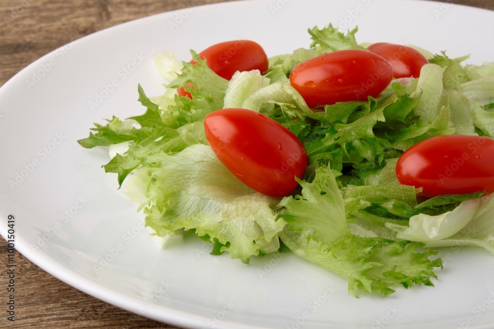 Fresh salad on a wooden background Fresh salad on a wooden background