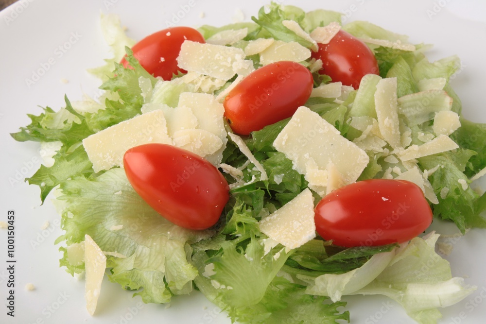 Fresh salad parmesan on a wooden background Fresh salad parmesan on a wooden background