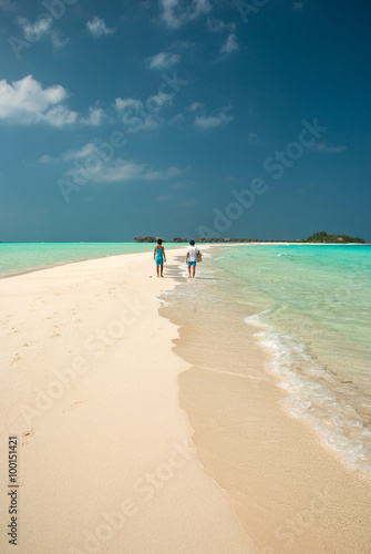 Couple walking in a maldivian island