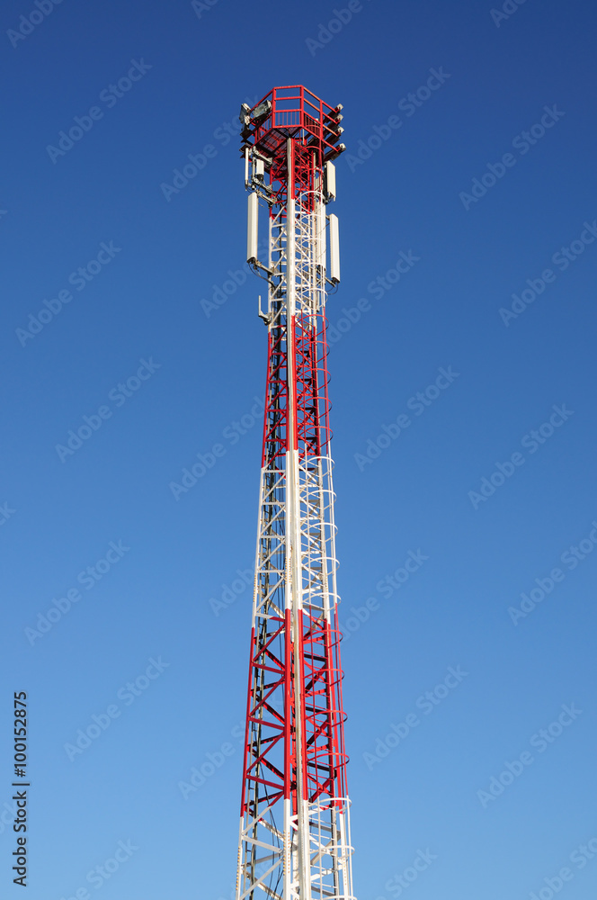 Cell tower and radio antenna, blue sky background Cell tower and radio antenna, blue sky background