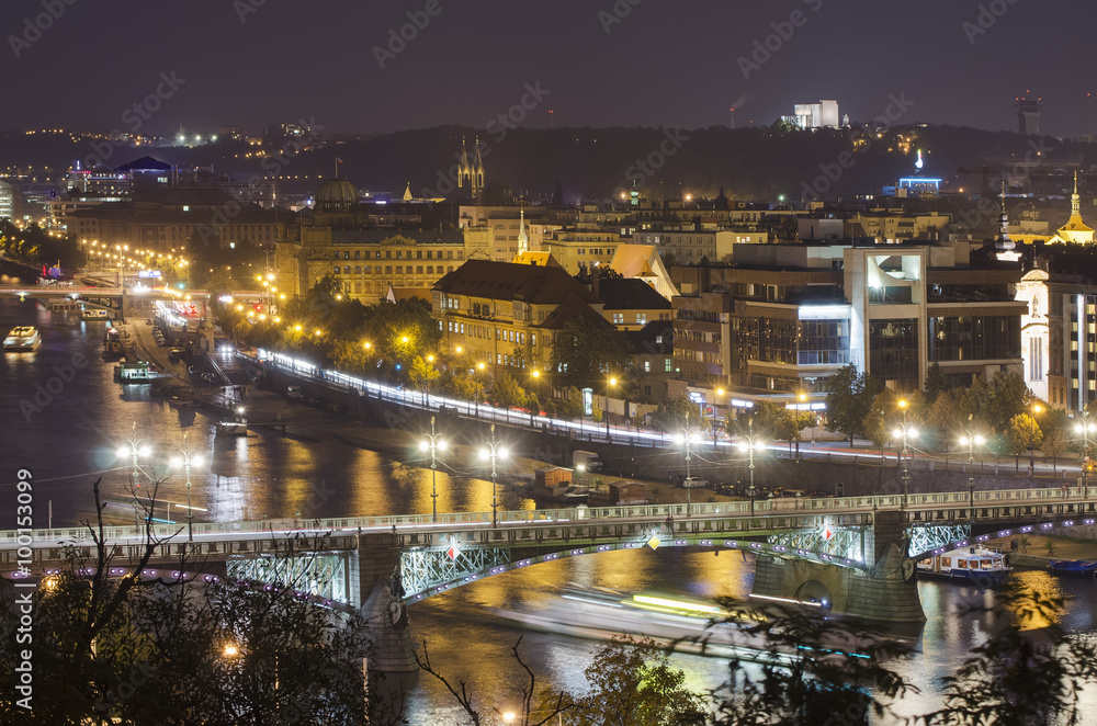 Night view of famous european Prague city - the capital pf Czech republic with reflection in river Vltava and historical bridges