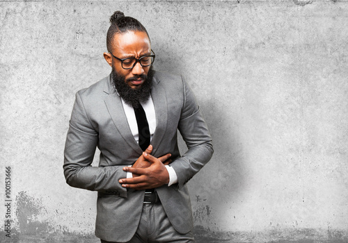 business black man suffering stomach ache