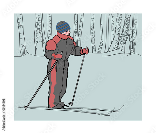 Boy on skis in the winter woods on a walk.