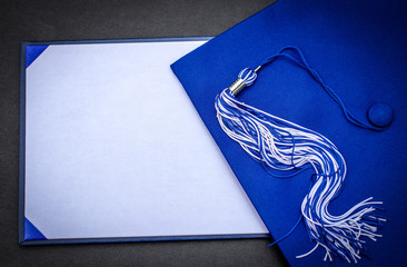 Graduation Day. Mortarboard, tassel  and blank diploma with copy space.