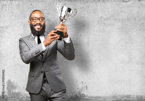 business black man holding a trophy