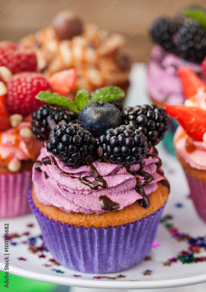 Delicious cupcake decorated with blueberry and blackberries