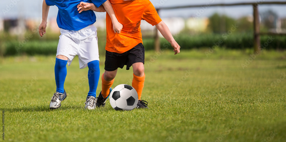 young boys playing football soccer game. Running players in blue and white uniforms young boys playing football soccer game. Running players in blue and white uniforms