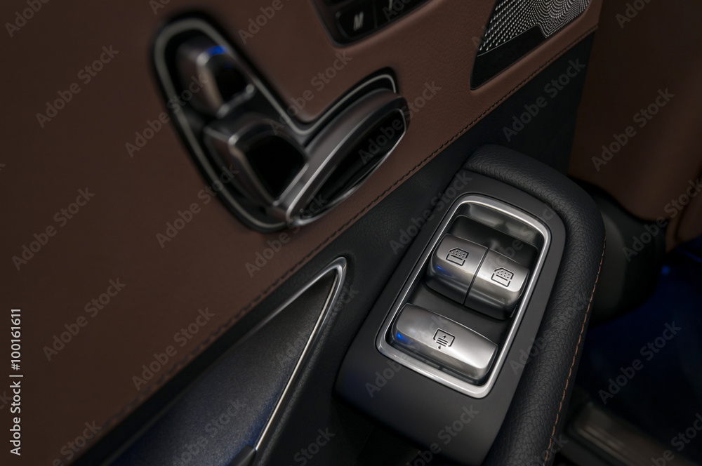 Luxury car window control buttons. Interior details.