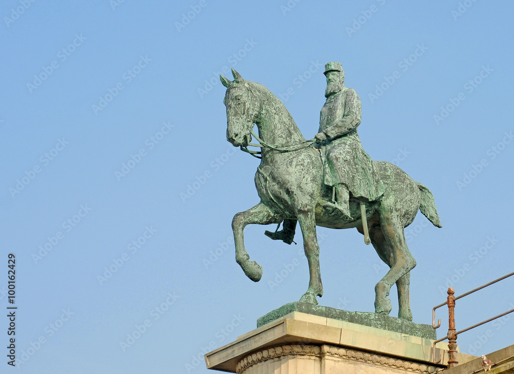 Antique bronze statue of king Leopold 2 on his horse against blue sky in Ostend, Belgium