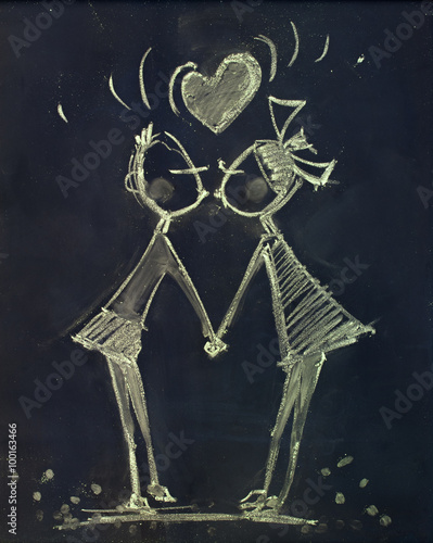 Young Couple in Kiss. Drawing on the Chalkboard