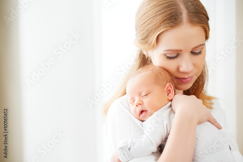 Obraz na plátně newborn baby in tender embrace of mother