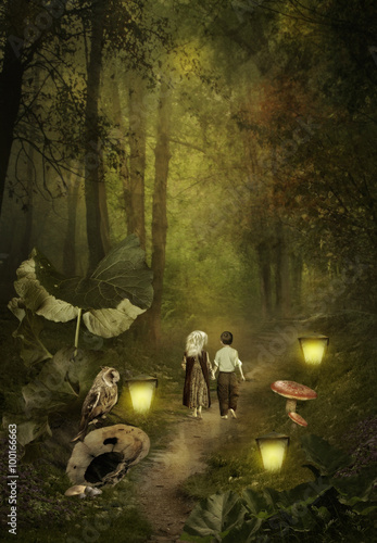 Young children go on a footpath lit by the light of lanterns in the dense forest.Hansel and Gretchen photo