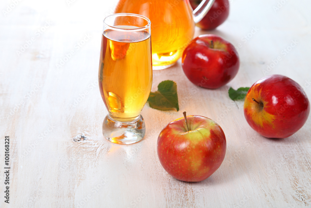 Apple juice and apples on a wooden table Apple juice and apples on a wooden table