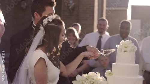 Newlywed couple cutting a traditional layered wedding cake, romantic lifestyle.