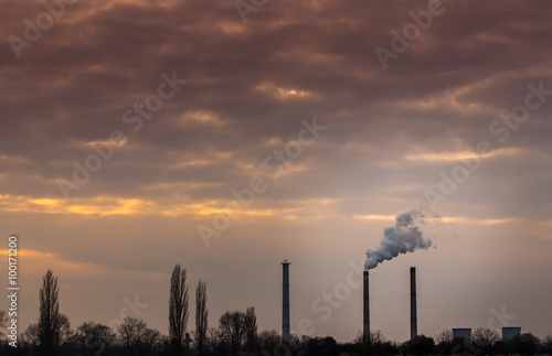 Industrial cityscape with coal power plant and smoke stacks