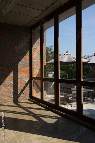 Large windows with light and shadow on brick wall