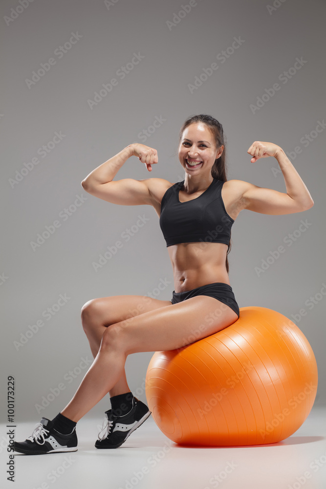 Fototapeta premium The young, beautiful, sports girl doing exercises on a fitball 