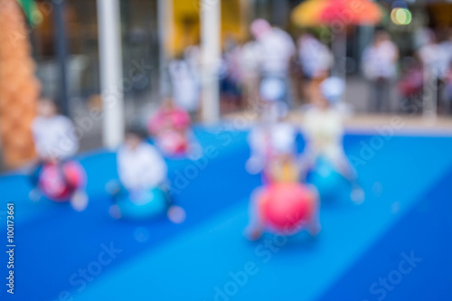 abstract blurred children playing playground in park background.