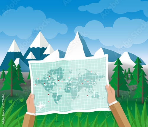 Man on a hiking trip holding map in his hands