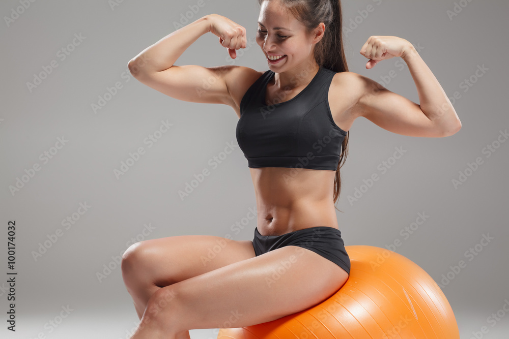 Fototapeta premium The young, beautiful, sports girl doing exercises on a fitball 