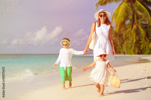 cute little girl walking on beach with family