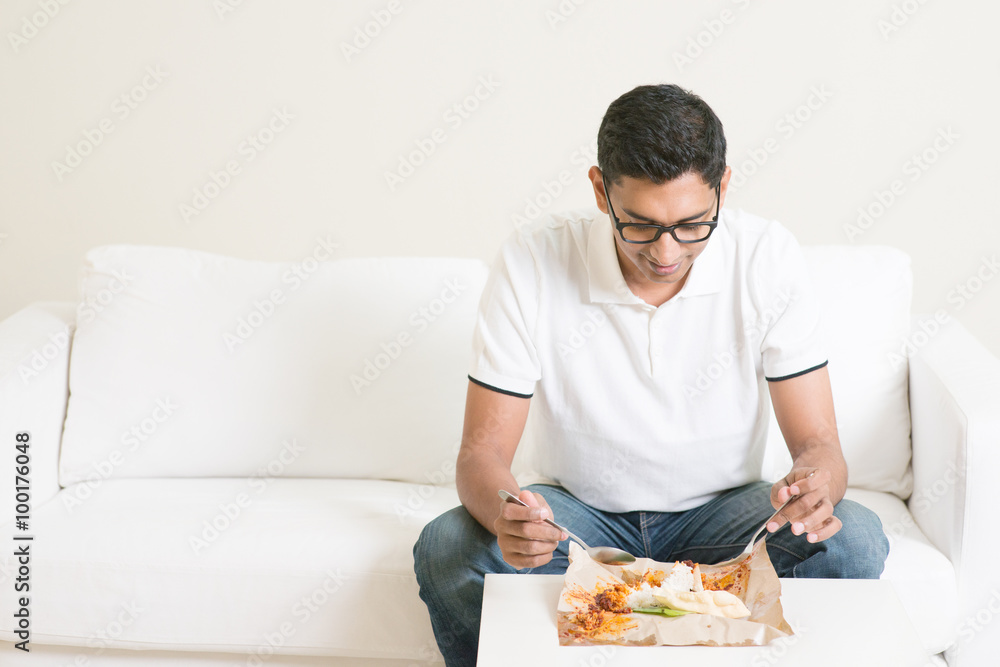 Lonely single man eating food alone at home