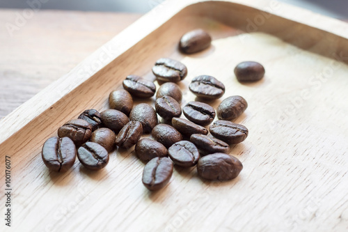 Selective coffee beans prepare for coffee brewing on the wood tray 