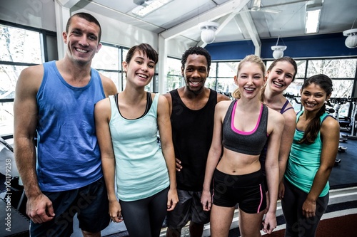 Smiling fitness class posing together 