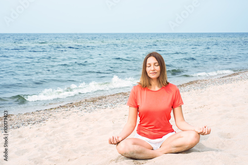 Woman meditating by the sea