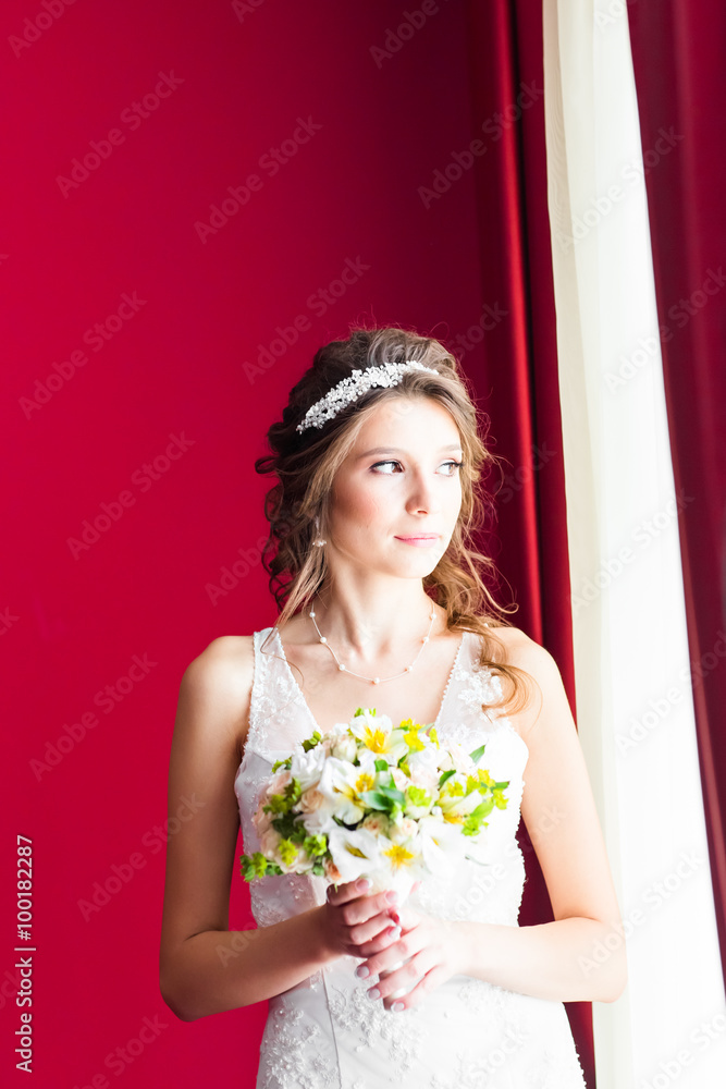 Beautiful young bride with wedding makeup and hairstyle in bedroom Beautiful young bride with wedding makeup and hairstyle in bedroom