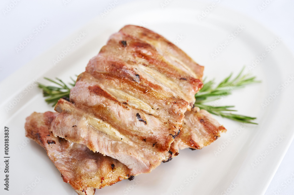 Pork ribs on white plate studio shot Pork ribs on white plate studio shot