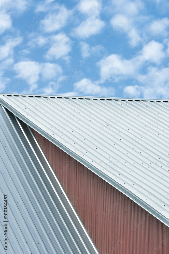 Industrial building roof sheets, grey steel rooftop pattern sky clouds riffled roofing red ocher wood texture background, red ochre paint wooden wall closeup, vertical gray corrugated metal copy space Industrial building roof sheets, grey steel rooftop pattern sky clouds riffled roofing red ocher wood texture background, red ochre paint wooden wall closeup, vertical gray corrugated metal copy space