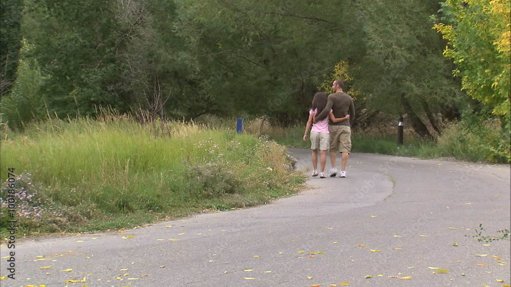 Couple going for a walk with arms around each other. Couple going for a walk with arms around each other.