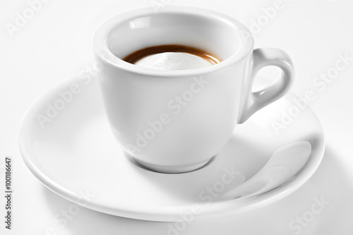 A cup of coffee on a plate isolated on white background. A cup of macchiato.