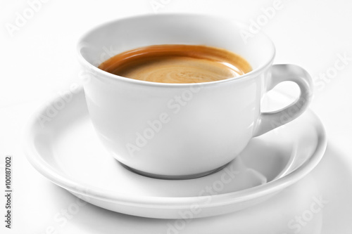 A cup of coffee on a plate isolated on white background. A cup of Americano. Focus on a cup