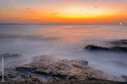 Long exposure seascape during blue hour sunset with rocks as foreground. Nature composition