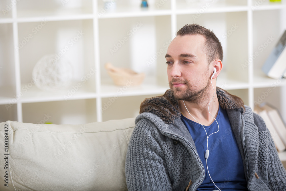 Smiling young man in headphones at home Smiling young man in headphones at home