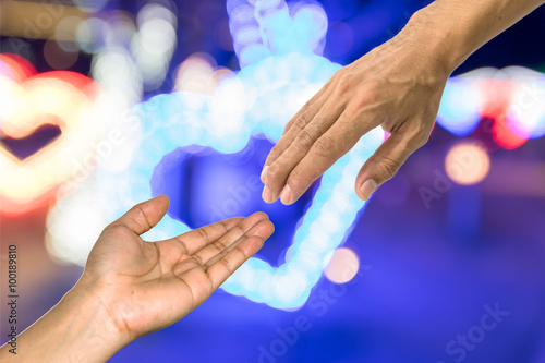 Helping hand symbol with LED lighting background.