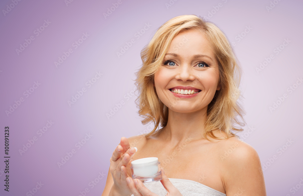 happy middle aged woman with cream jar happy middle aged woman with cream jar