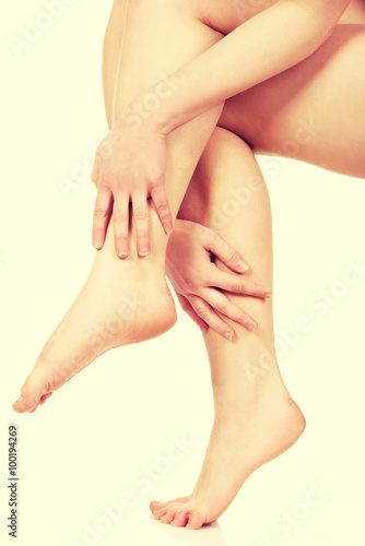 Woman massaging her legs.