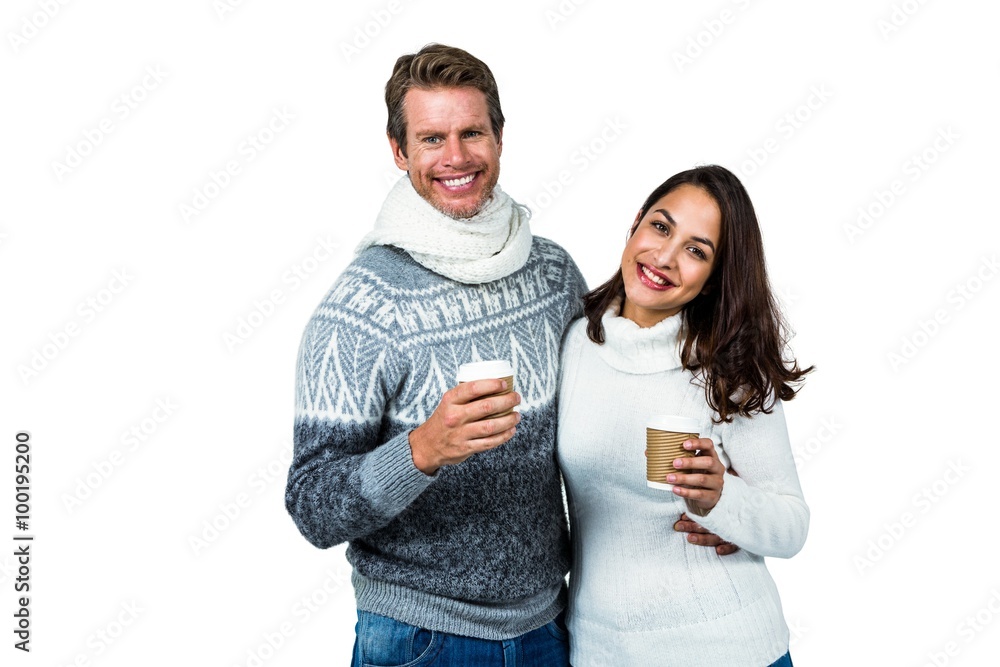 Festive couple smiling and holding mugs Festive couple smiling and holding mugs