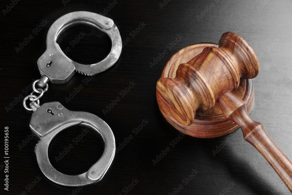 Real Judges Gavel And Handcuffs On The Black Table Real Judges Gavel And Handcuffs On The Black Table