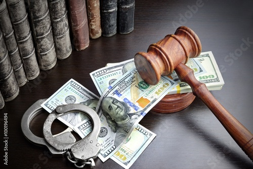 Judges Gavel, Handcuffs, Dollar Cash And Book On  Black Table