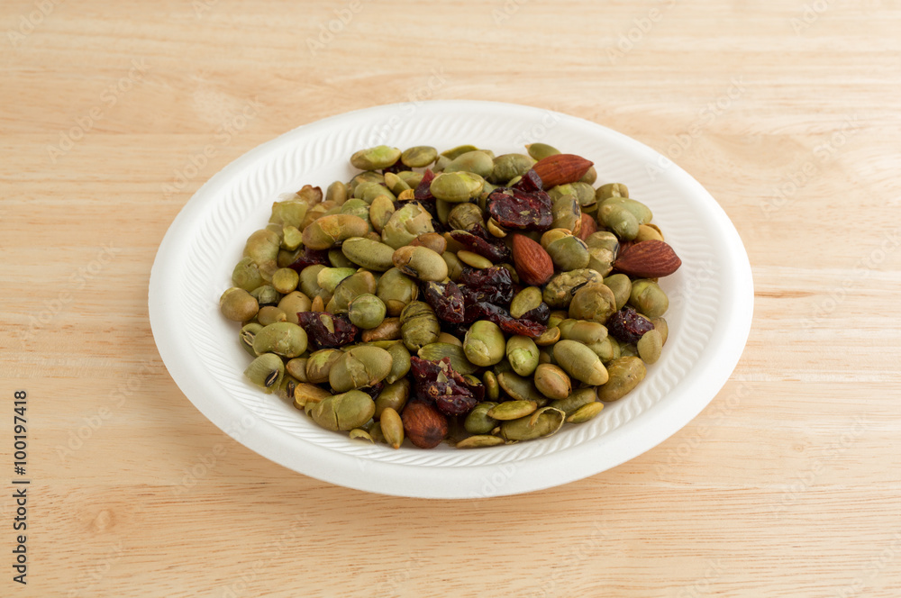 Edamame with nuts and dried fruit on white plate Edamame with nuts and dried fruit on white plate