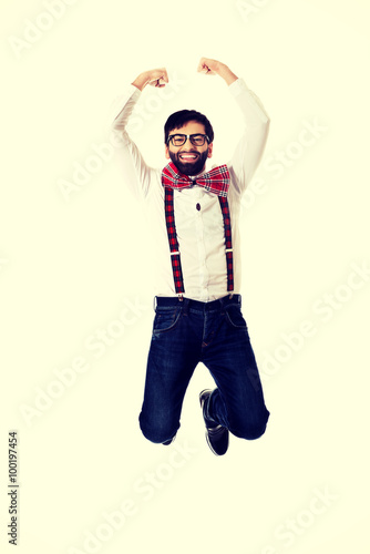 Old fashioned man wearing suspenders jumping.