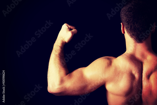 Sexy muscular man showing his muscular back.