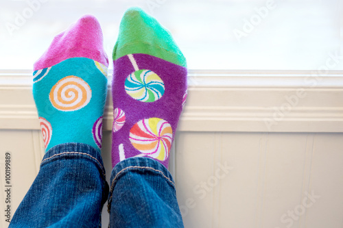 Pair of odd socks on feet
