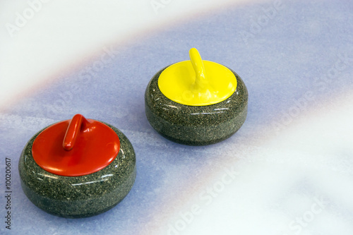 Two curling stone on Ice
