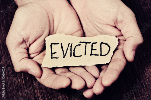 man with a piece of paper with the word evicted